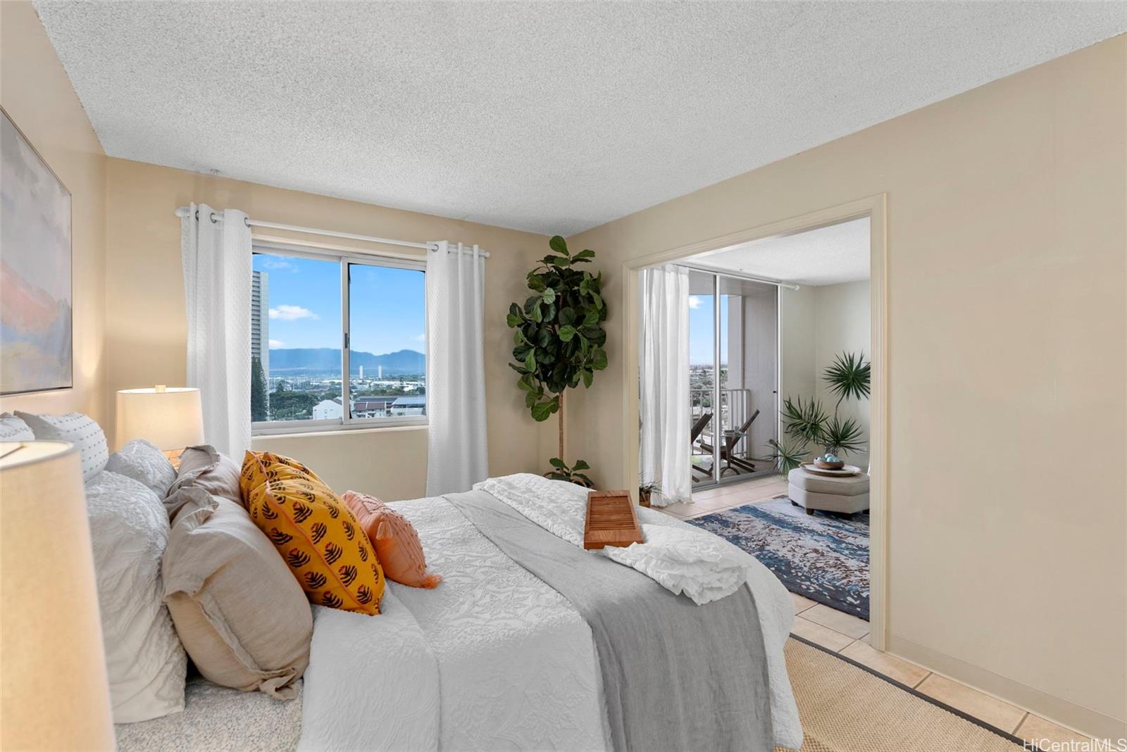 98-1038 Moanalua Road, Unit 1502 Aiea, HI 96701 - Photo 4 of 20 a bedroom with a large bed and a potted plant