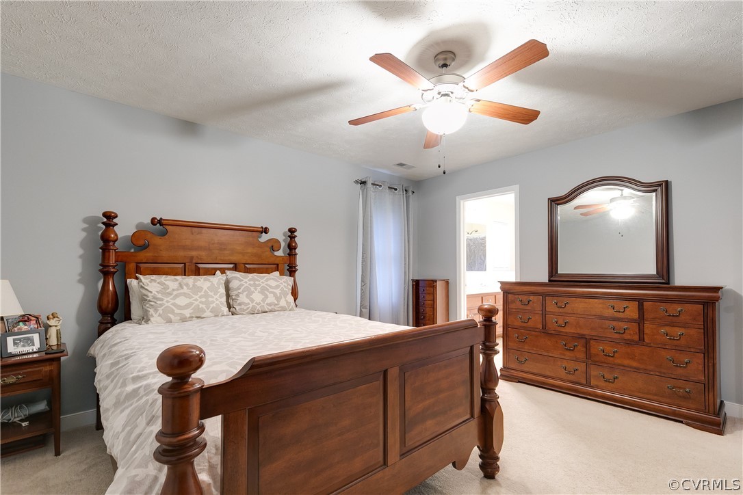 473 Winding Ridge Way Bumpass, VA 23024 - Photo 13 of 25 a bedroom with a bed and dresser