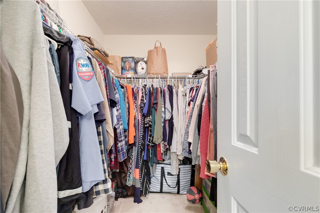 473 Winding Ridge Way Bumpass, VA 23024 - Photo 15 of 25 a view of walk in closet with clothes