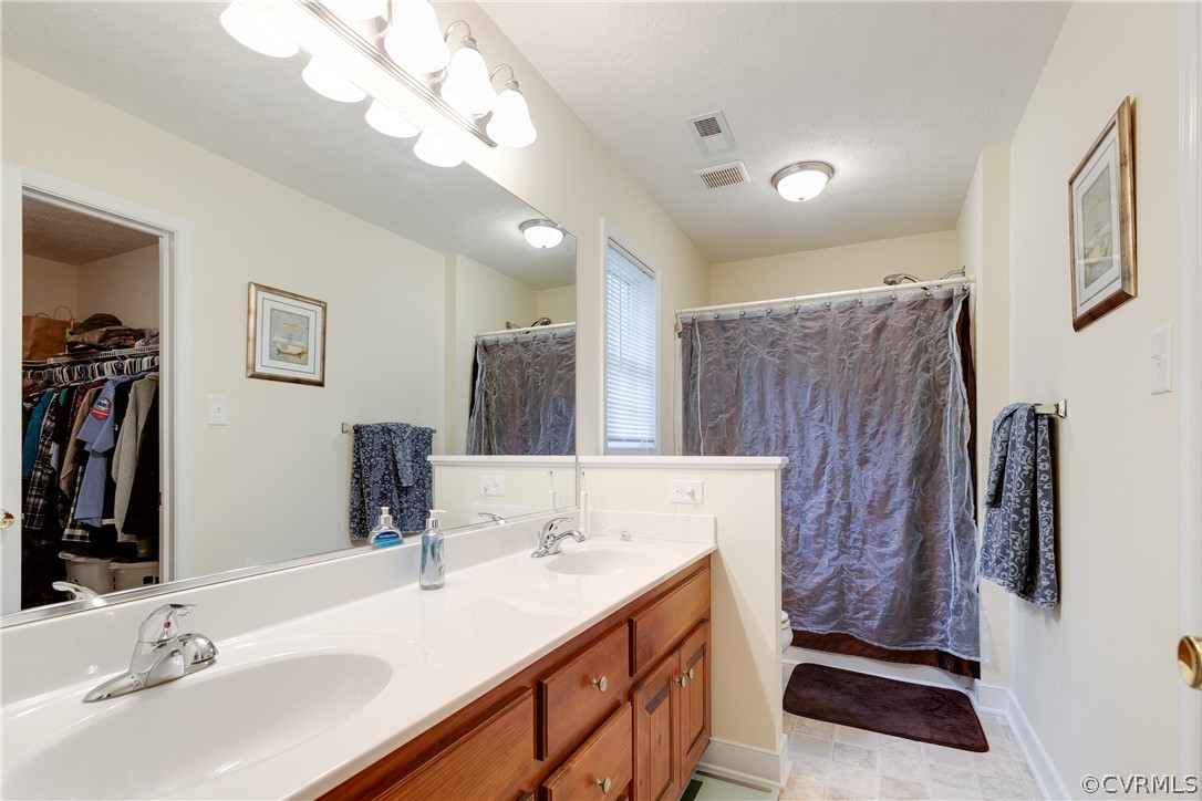 473 Winding Ridge Way Bumpass, VA 23024 - Photo 16 of 25 a bathroom with a sink double vanity and a mirror
