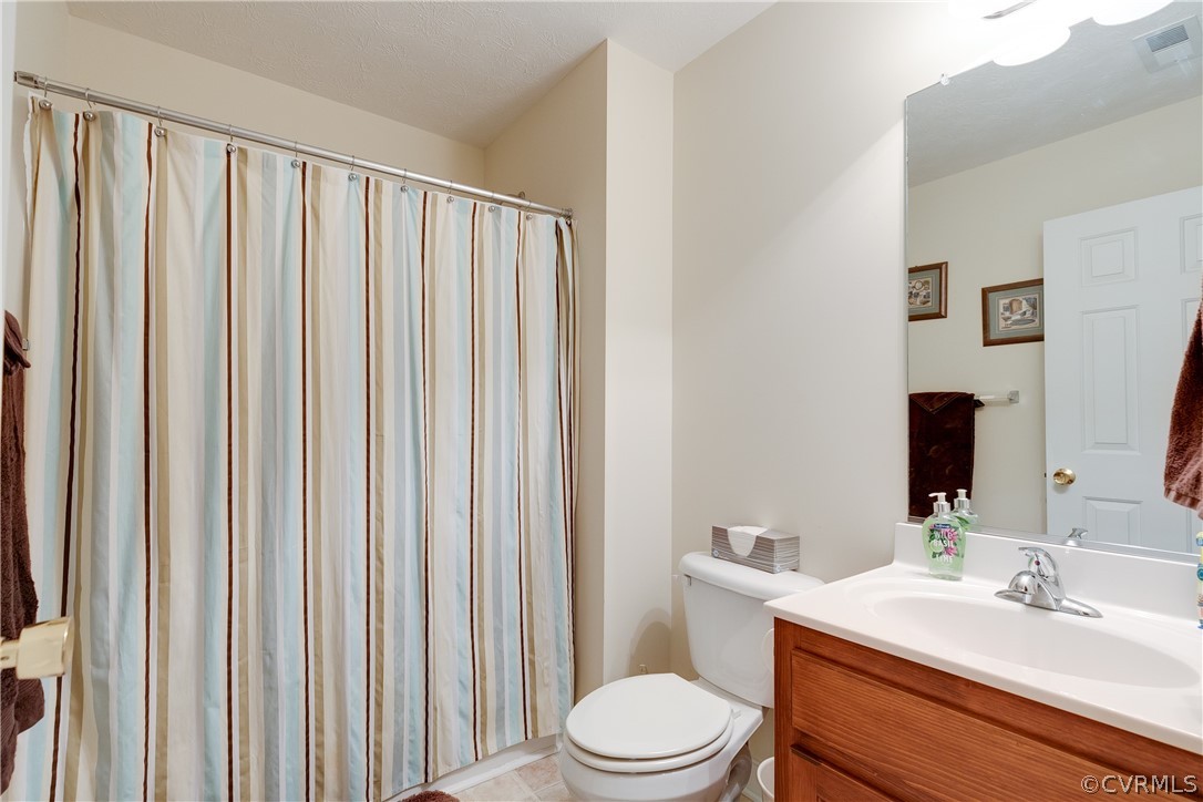 473 Winding Ridge Way Bumpass, VA 23024 - Photo 19 of 25 a bathroom with a toilet a sink and a mirror