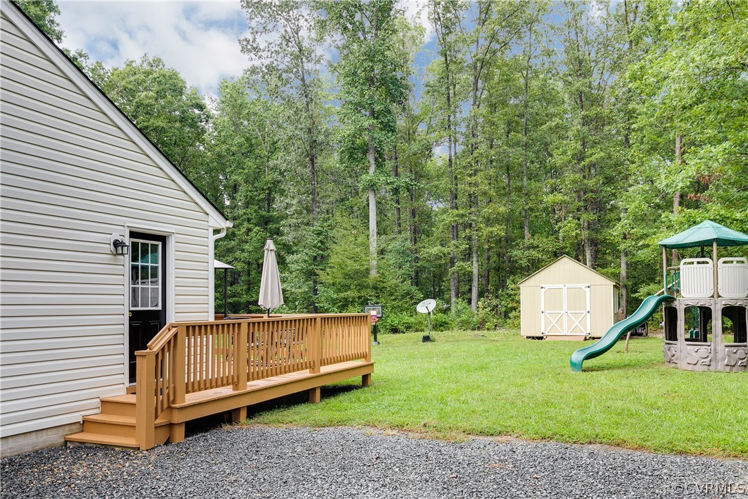 473 Winding Ridge Way Bumpass, VA 23024 - Photo 23 of 25 a view of a small house with backyard and a slide