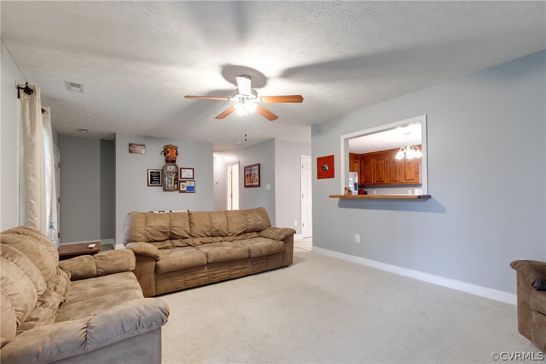 473 Winding Ridge Way Bumpass, VA 23024 - Photo 5 of 25 a living room with furniture and a ceiling fan