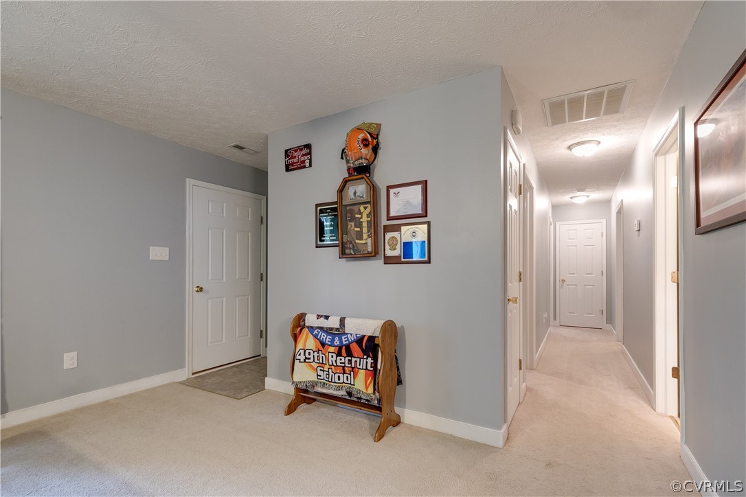 473 Winding Ridge Way Bumpass, VA 23024 - Photo 6 of 25 a view of a hallway with paintings on the wall