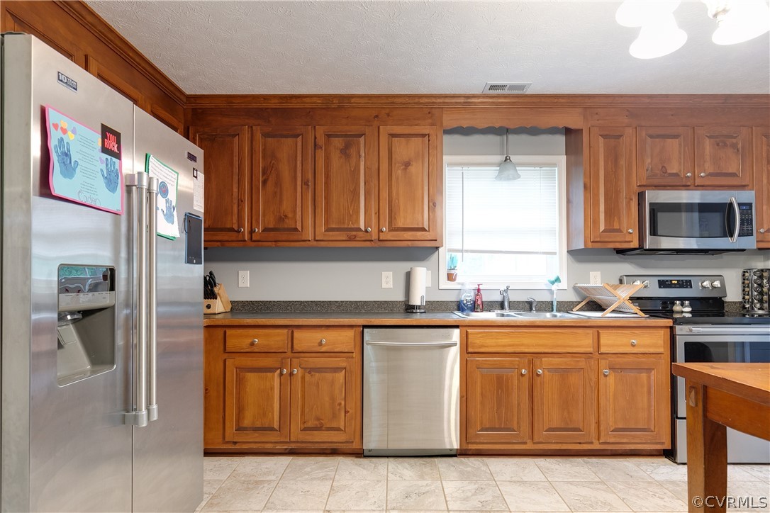 473 Winding Ridge Way Bumpass, VA 23024 - Photo 7 of 25 a kitchen with stainless steel appliances granite countertop a refrigerator and a stove top oven