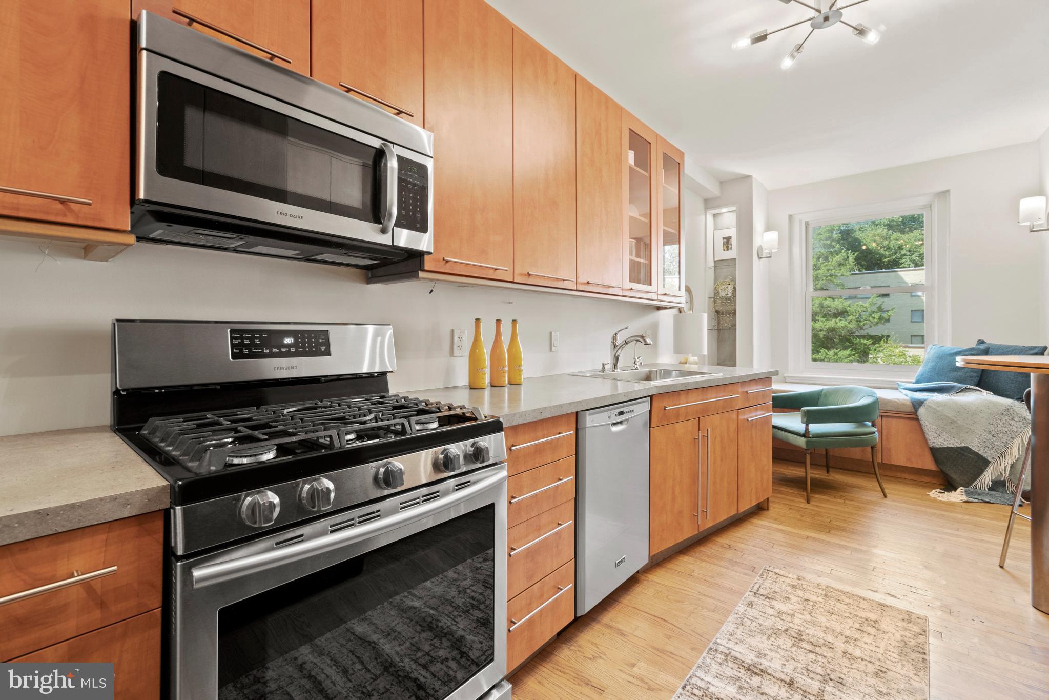 3601 Connecticut Avenue Northwest, Unit 106 Washington, DC 20008 - Photo 12 of 34 a kitchen with a stove a sink and a microwave
