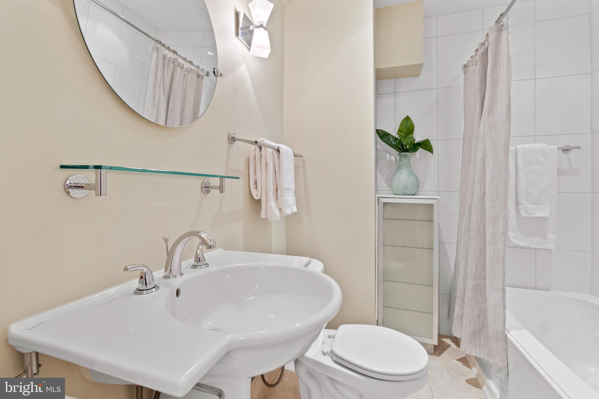 3601 Connecticut Avenue Northwest, Unit 106 Washington, DC 20008 - Photo 18 of 34 a bathroom with a sink a toilet and shower