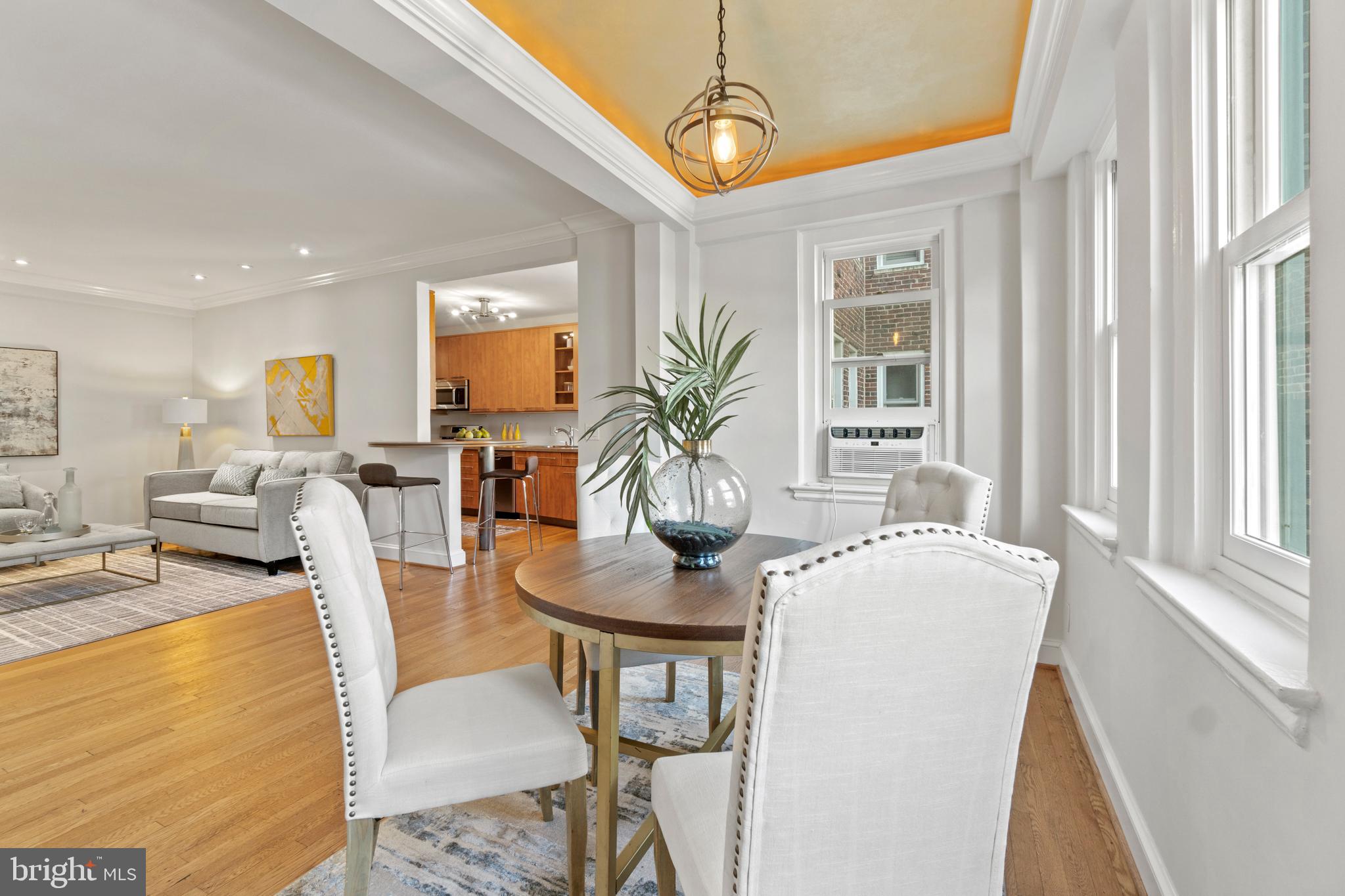 3601 Connecticut Avenue Northwest, Unit 106 Washington, DC 20008 - Photo 7 of 34 a view of a dining room with furniture window and wooden floor