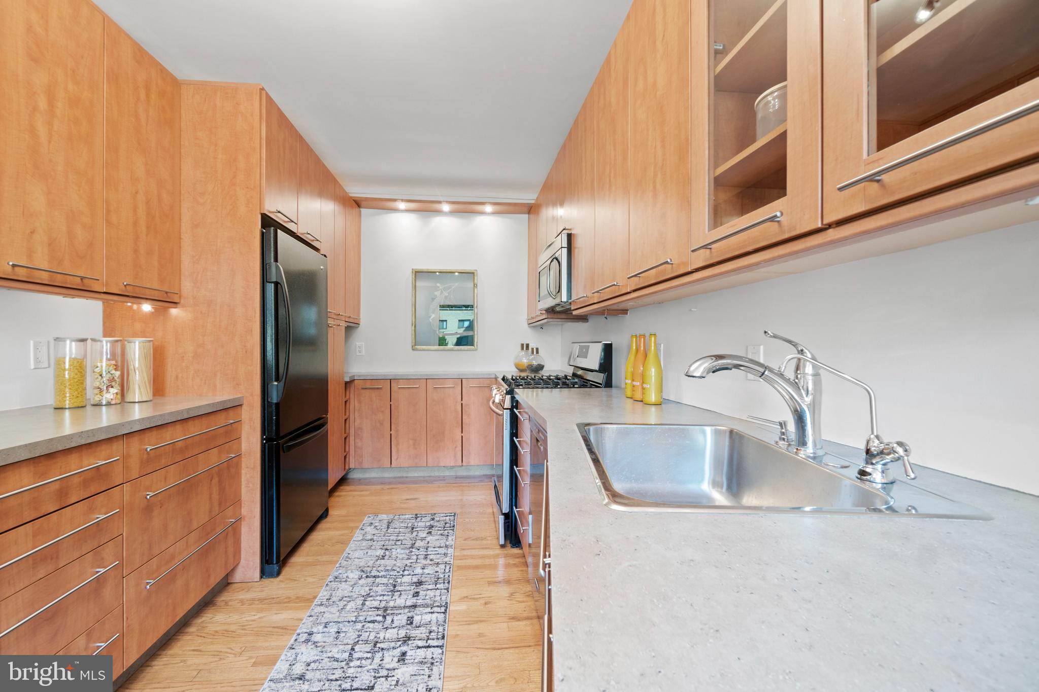 3601 Connecticut Avenue Northwest, Unit 106 Washington, DC 20008 - Photo 10 of 34 a kitchen with stainless steel appliances granite countertop a sink and a refrigerator