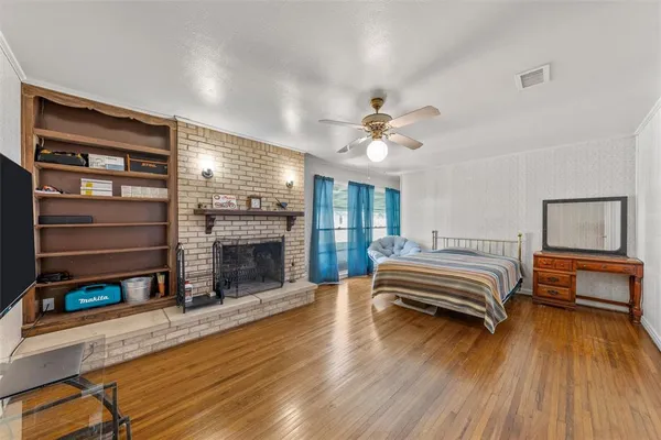 a spacious bedroom with a bed and a chandelier