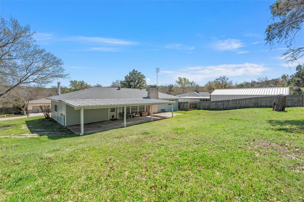 110 Butler Drive Valley Mills, TX 76689 - Photo 25 of 26 a view of a house with a big yard potted plants and a large tree