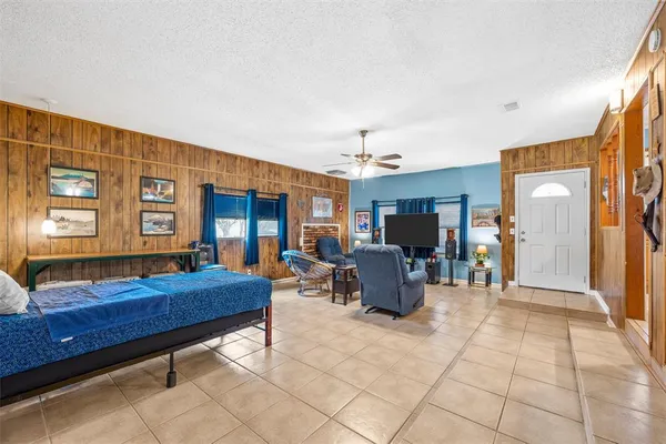 a living room with furniture and dining table