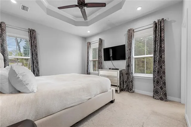 a bedroom with a bed tv and a window