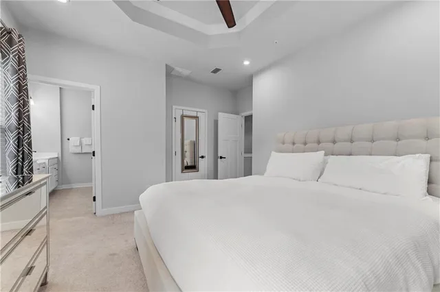 a large white bed in a white room