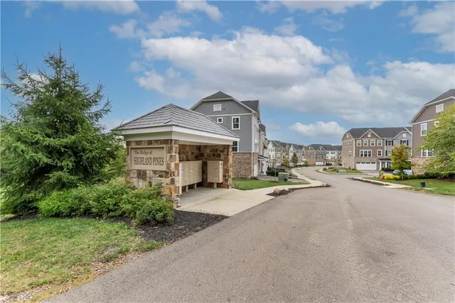 a front view of a house with a garden and pathway