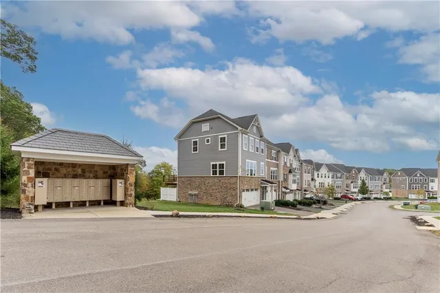 a front view of a house with a garden and balcony