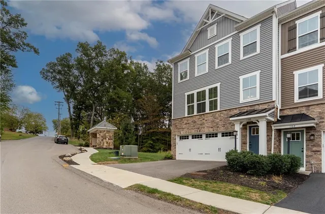 a front view of a house with a garden