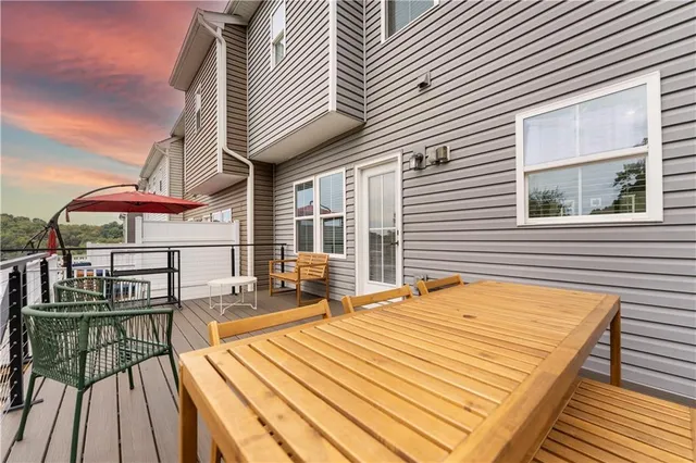 a view of a balcony with wooden floor and seating space