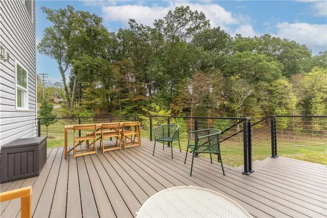 a view of a balcony with chairs and wooden floor