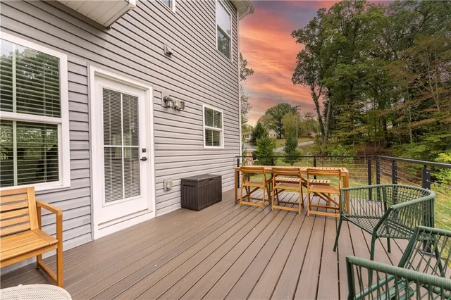 a view of a balcony with wooden floor and outdoor seating