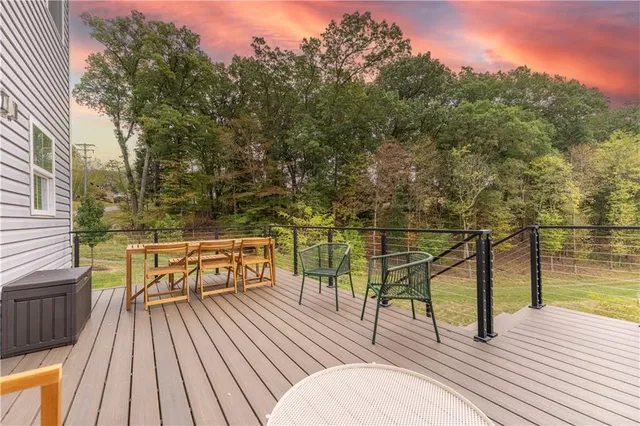 a view of balcony with wooden floor and outdoor seating