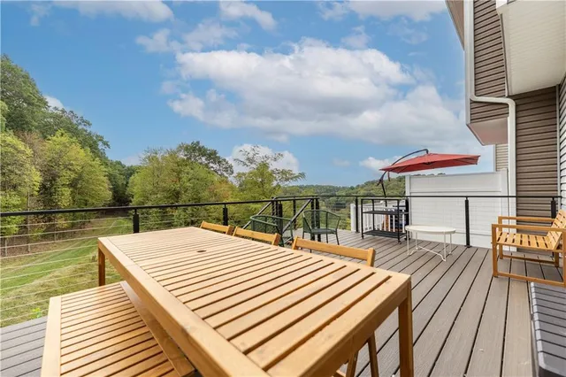 a balcony with table and chairs