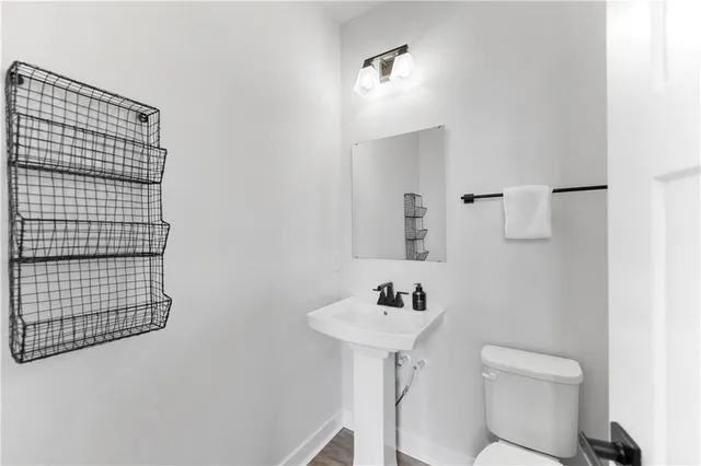 a bathroom with a sink toilet and mirror