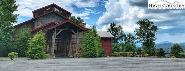 a living room with fireplace furniture and a large window