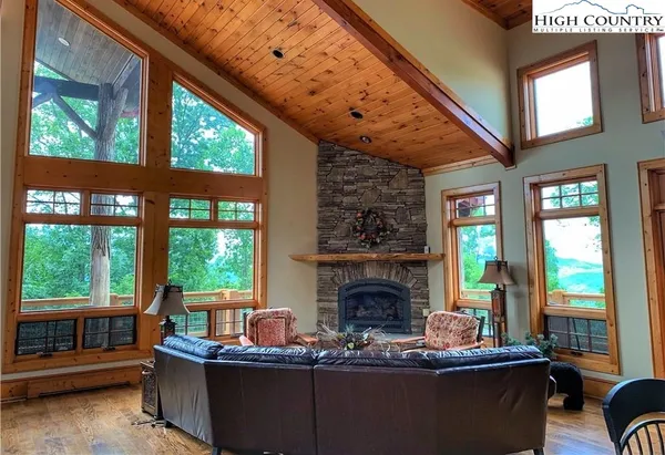 a living room with furniture and large windows