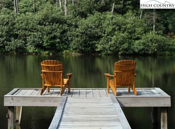 a view of a deck with a table and chairs under an umbrella