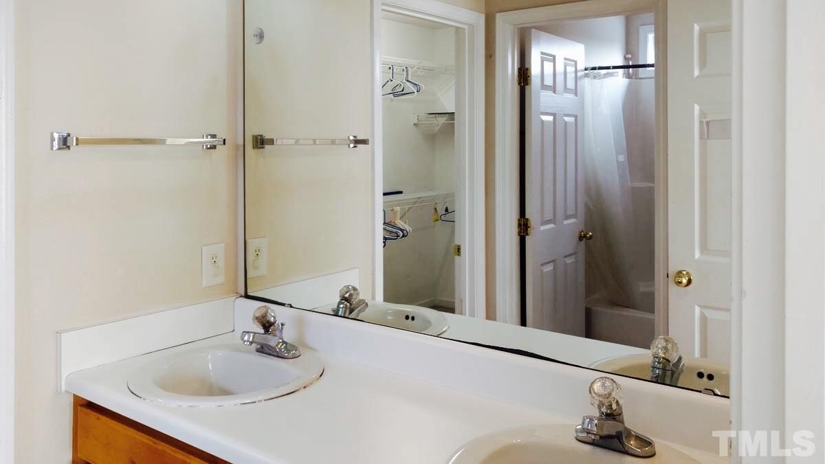 1908 Cartier Ruby Lane Raleigh, NC 27610 - Photo 14 of 15 a bathroom with a granite countertop sink and a mirror