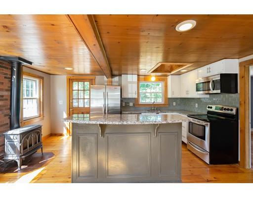 97 Meadowbrook Road Chelmsford, MA 01863 - Photo 6 of 15 a kitchen with stainless steel appliances granite countertop a sink a stove and a microwave