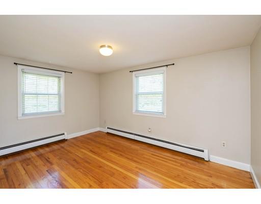 97 Meadowbrook Road Chelmsford, MA 01863 - Photo 8 of 15 an empty room with wooden floor and windows