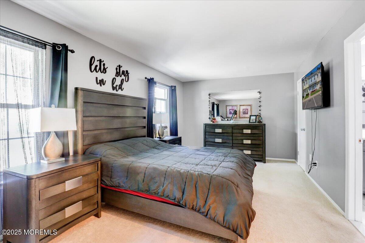 111 Joan Court Jackson, NJ 08527 - Photo 11 of 22 a bedroom with a bed and a flat screen tv