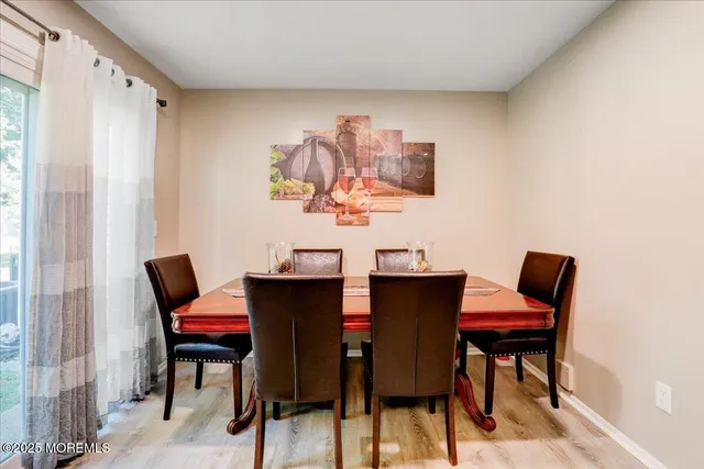 a view of a dining room with furniture and a window