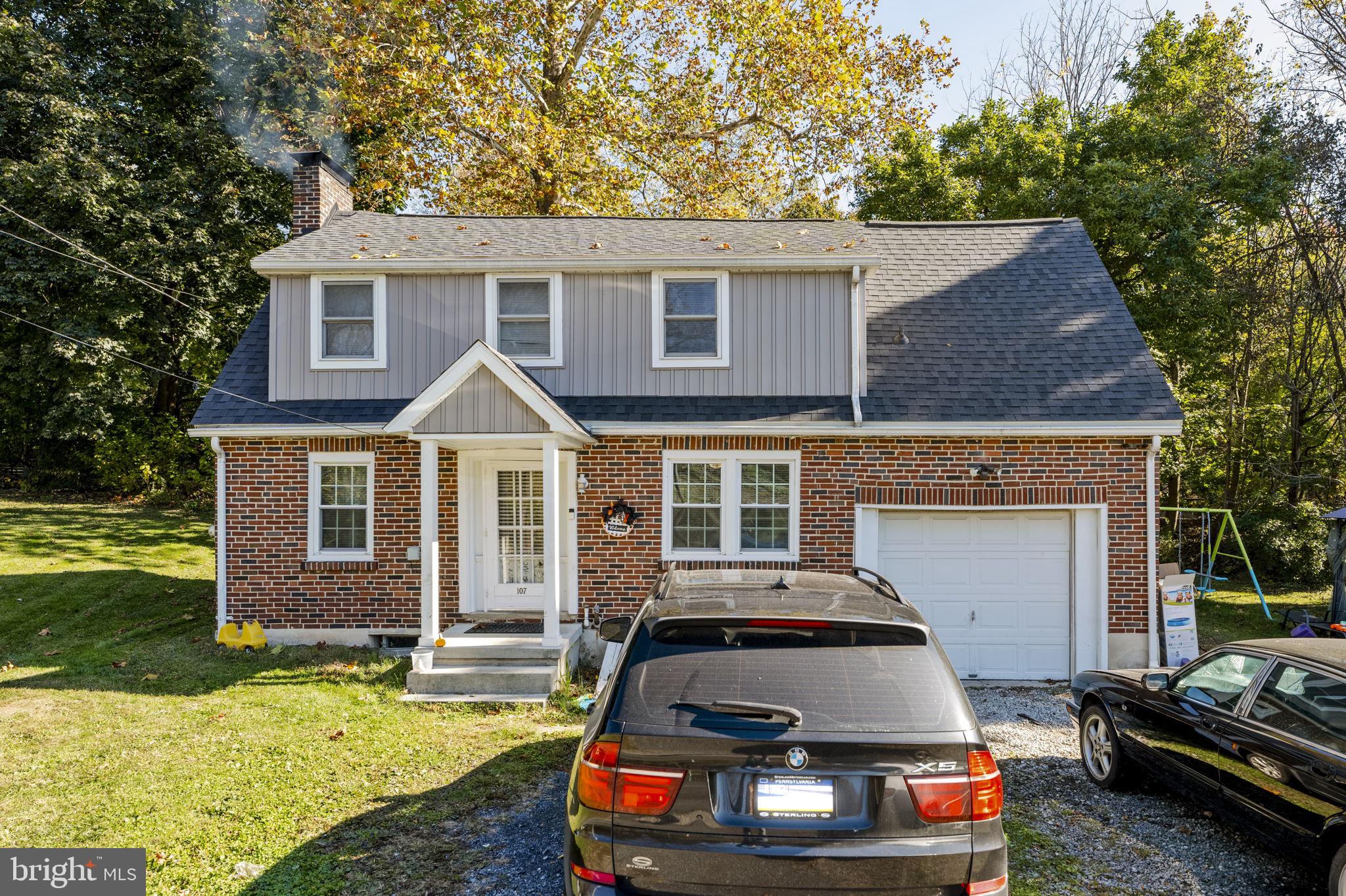 Charming brick home with lush surroundings.