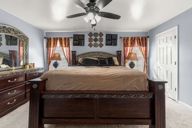 a bedroom with a bed and a chandelier