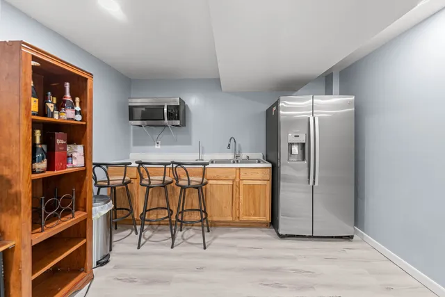 a kitchen with stainless steel appliances granite countertop a refrigerator and a stove top oven
