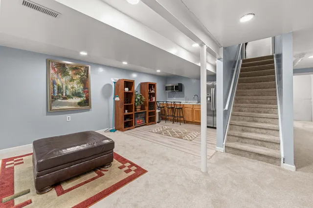 a living room with furniture and a ceiling fan