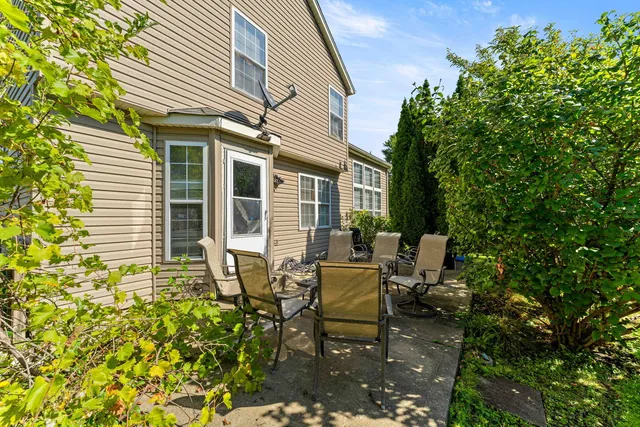 a view of a house with backyard and sitting area