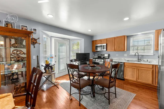 a view of a dining room with furniture window and wooden floor