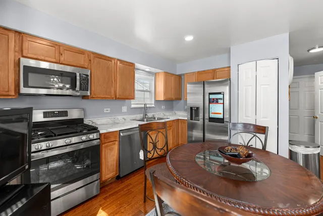 a kitchen with stainless steel appliances granite countertop a stove a sink and a microwave