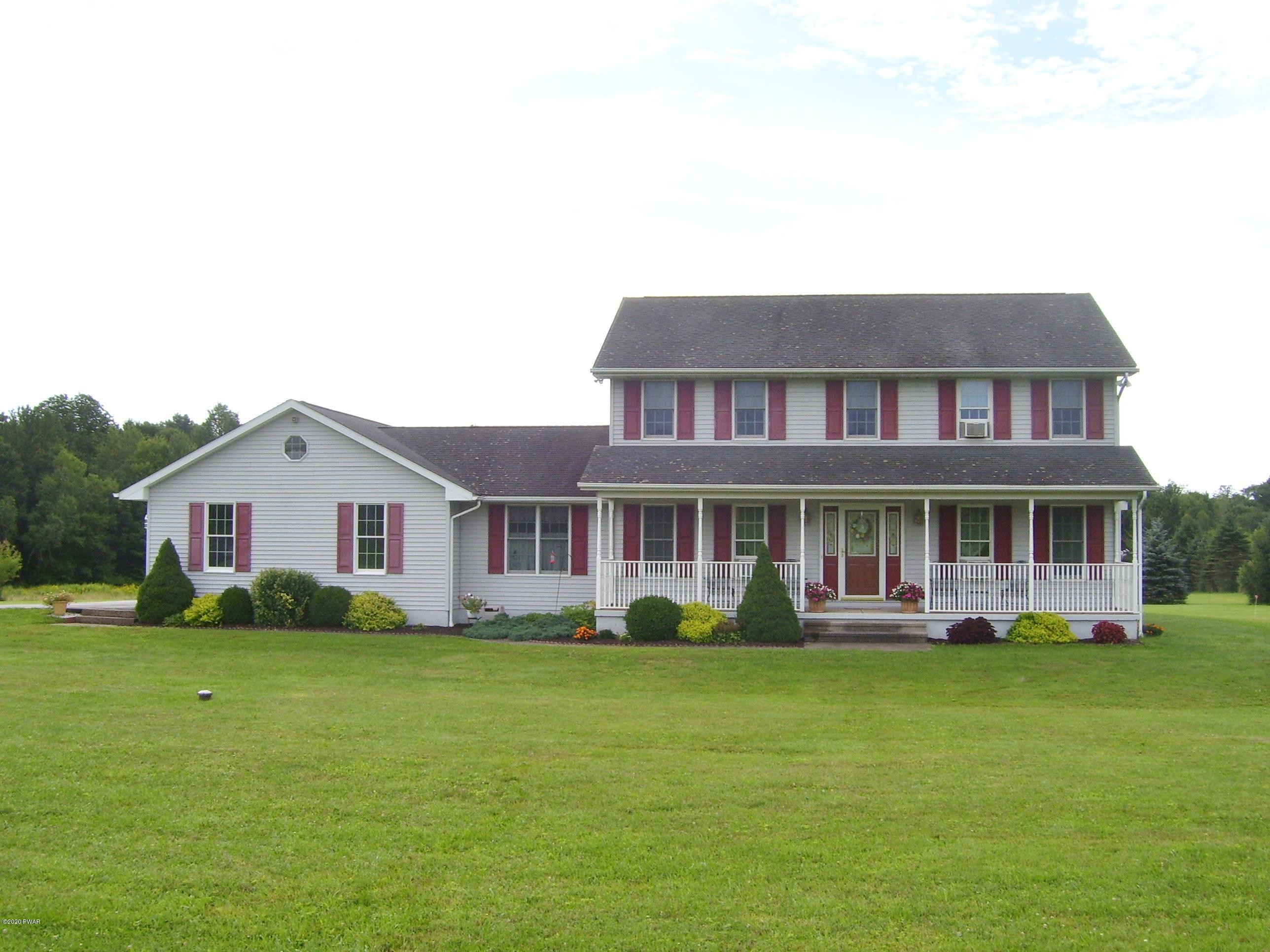 50 Layton Road Waymart, PA 18472 - Photo 2 of 61 a front view of a house with garden and plants