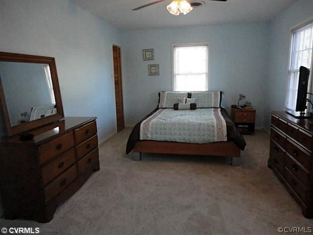7349 Drexelbrook Road Chesterfield, VA 23832 - Photo 18 of 24 a bedroom with a bed and a flat tv screen on the dresser