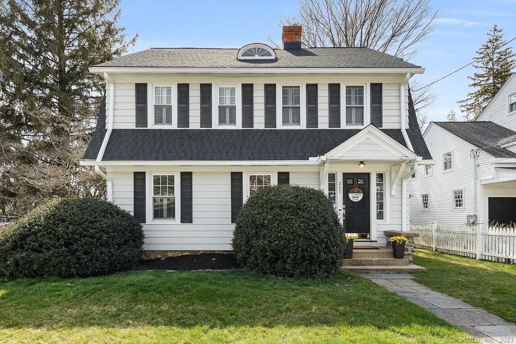 a front view of a house with a garden