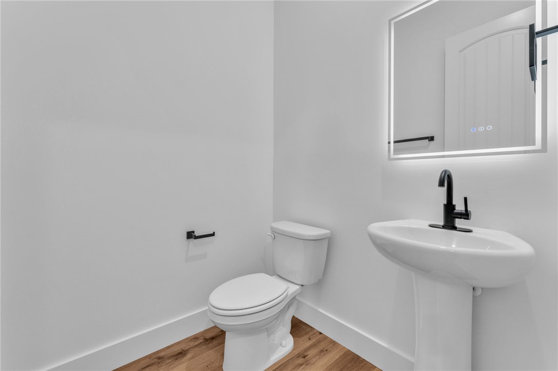 1727 Harris Bridge Road Anderson, SC 29621 - Photo 12 of 35 A well-appointed lavatory features modern fixtures and sleek hardwood flooring.
