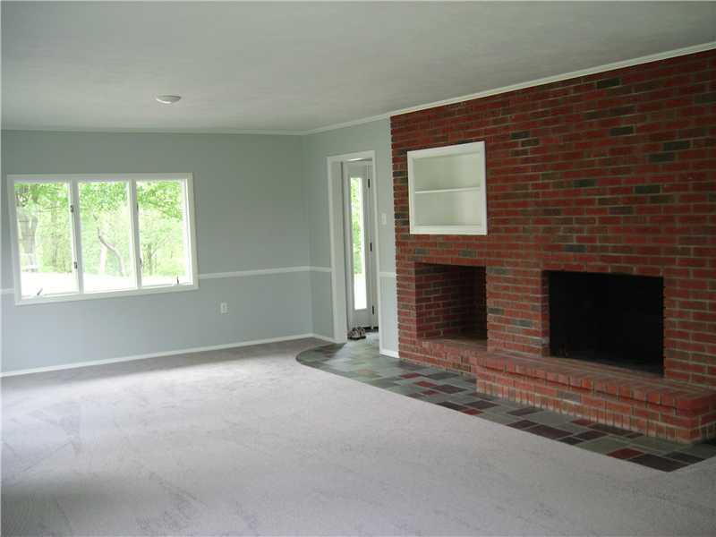 1047 Temple Road Aliquippa, PA 15001 - Photo 5 of 22 Living Room. Living room looking into foyer showing log burning fireplace.