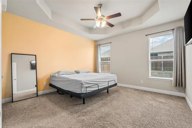 a spacious bedroom with a bed and a window
