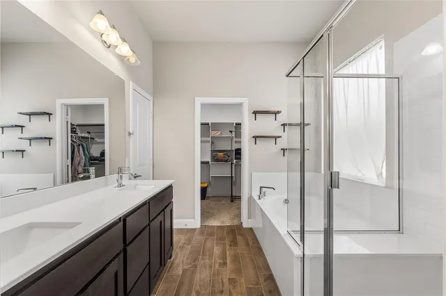 a bathroom with a double vanity sink mirror and shower