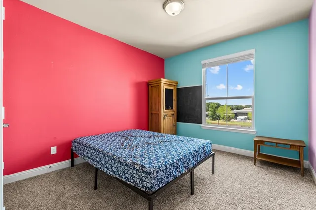 a bedroom with a bed and a dresser